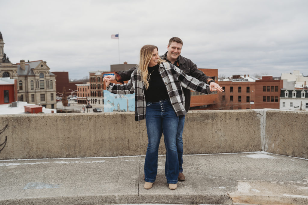 Couple stands together at the top of a parking garage in downtown Findlay.