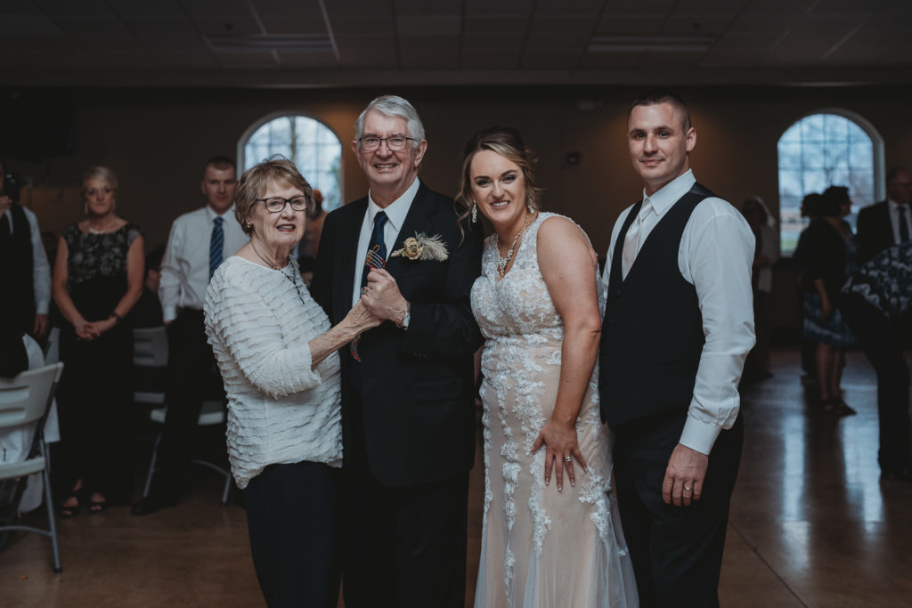 Bride and Groom pose with Bride's Grandparents who just won the Anniversary Dance