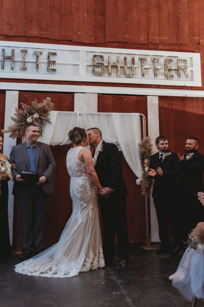 Bride and Grooms first kiss at their winery wedding at White Shutter Winery